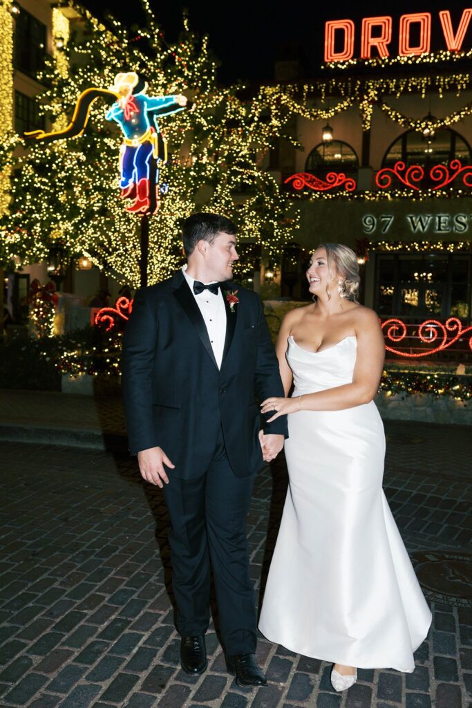 Bride and groom pose outside Hotel Drover