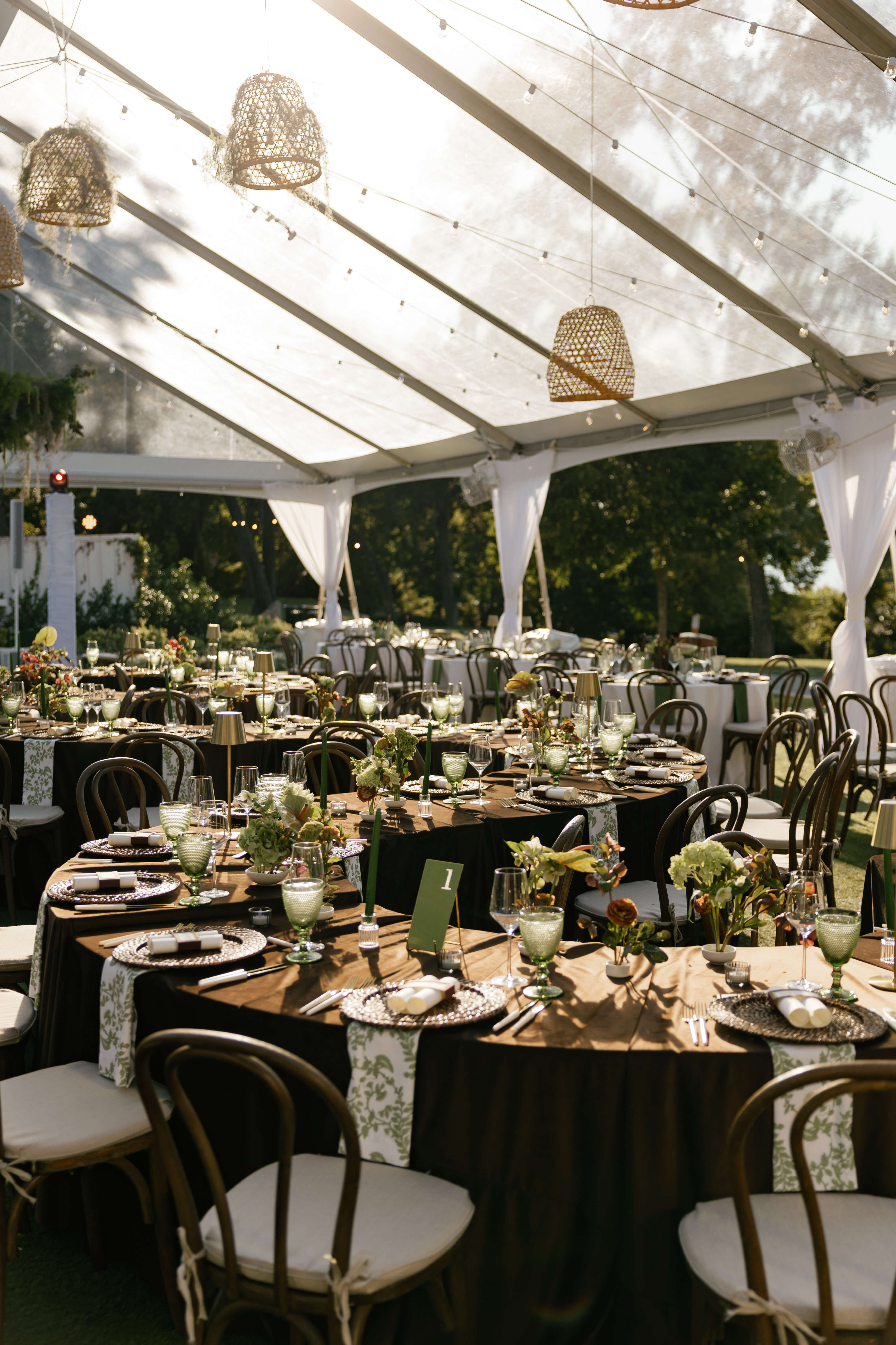 Oversized serpentine table in a tented reception at Dallas Arboretum